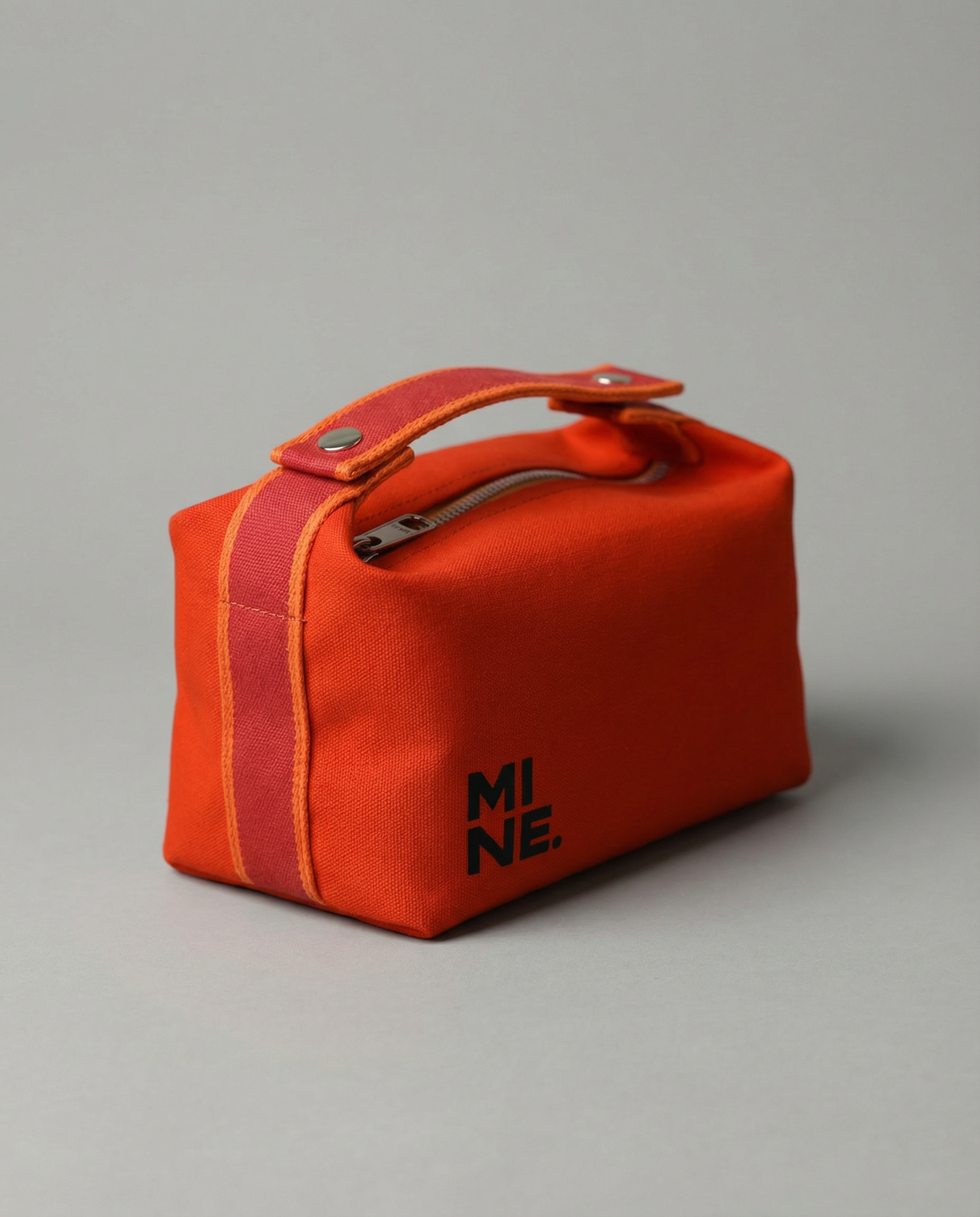 Red bag with 'MI NE' branding on a gray background