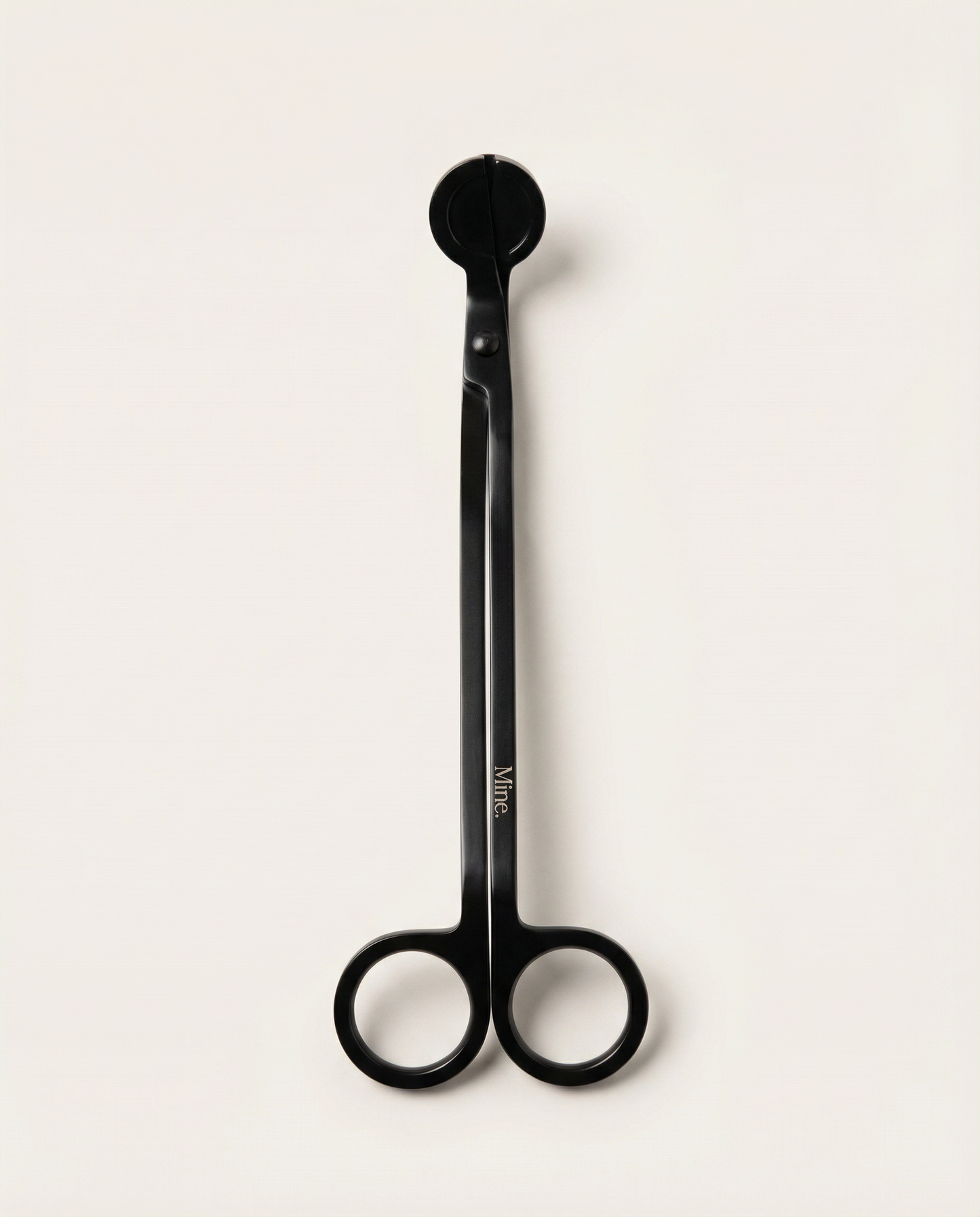 Black scissors with a visible brand logo on a white background